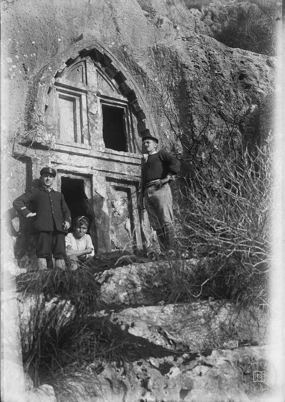 Three People Behind Antiphellos Rock Tomb