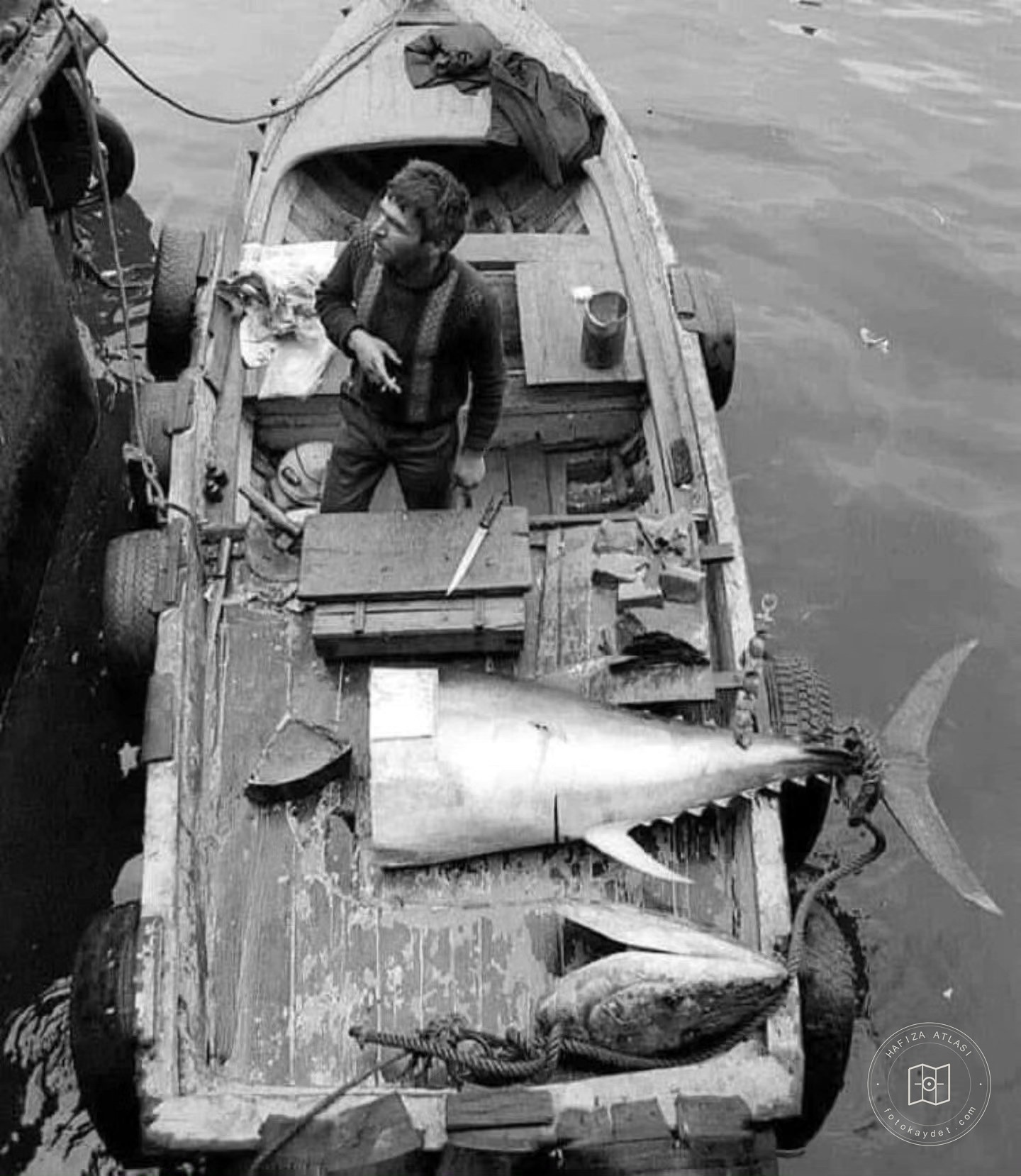 A fisherman selling tuna from a boat at Galata Bridge, 1979