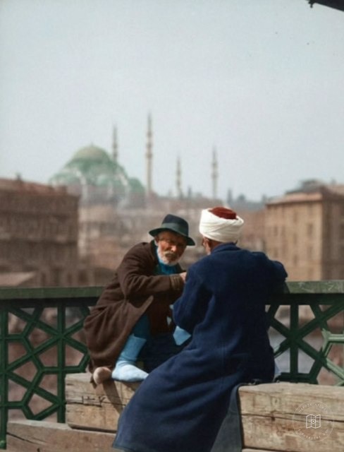 Two people talking on Galata Bridge, 1920s