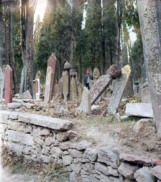 A person looking between gravestones in Karacaahmet, 1900