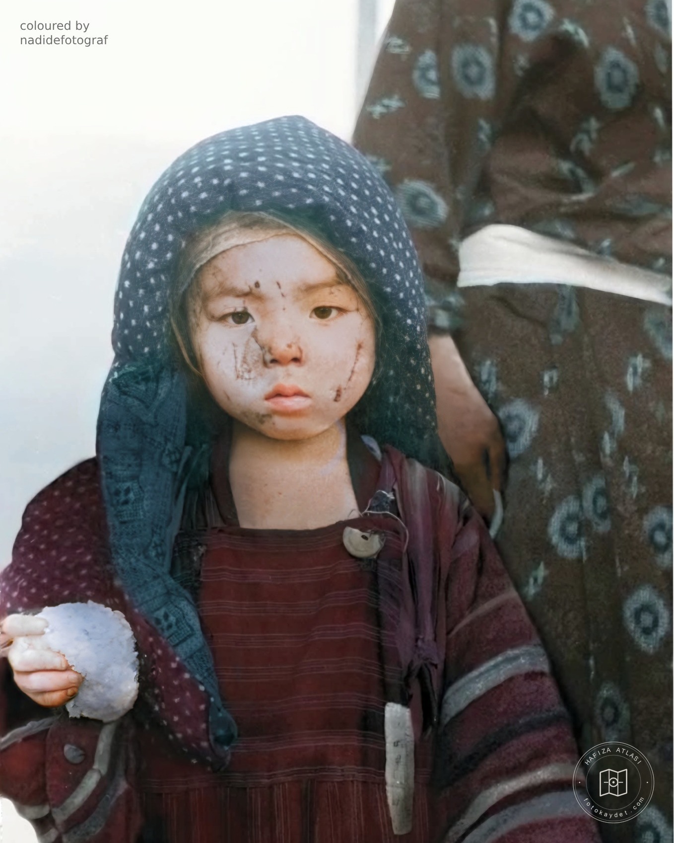 A child holding a rice ball in Nagasaki, 1945