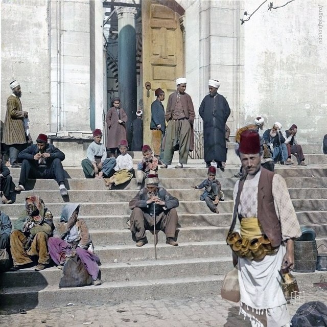 People sitting on the steps of Fatih Mosque, 1905
