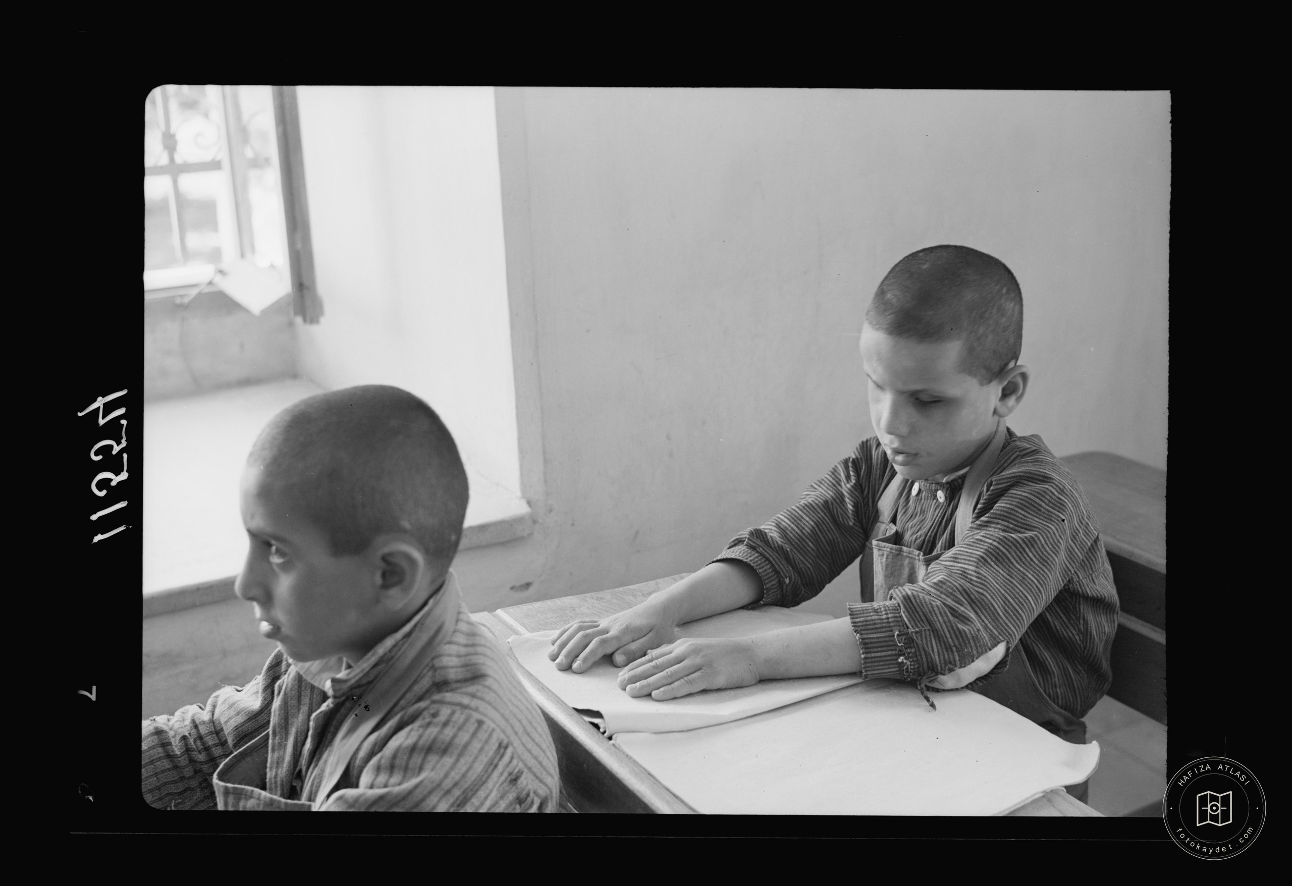 Blind school in Hebron. Close up of small boy reading braille