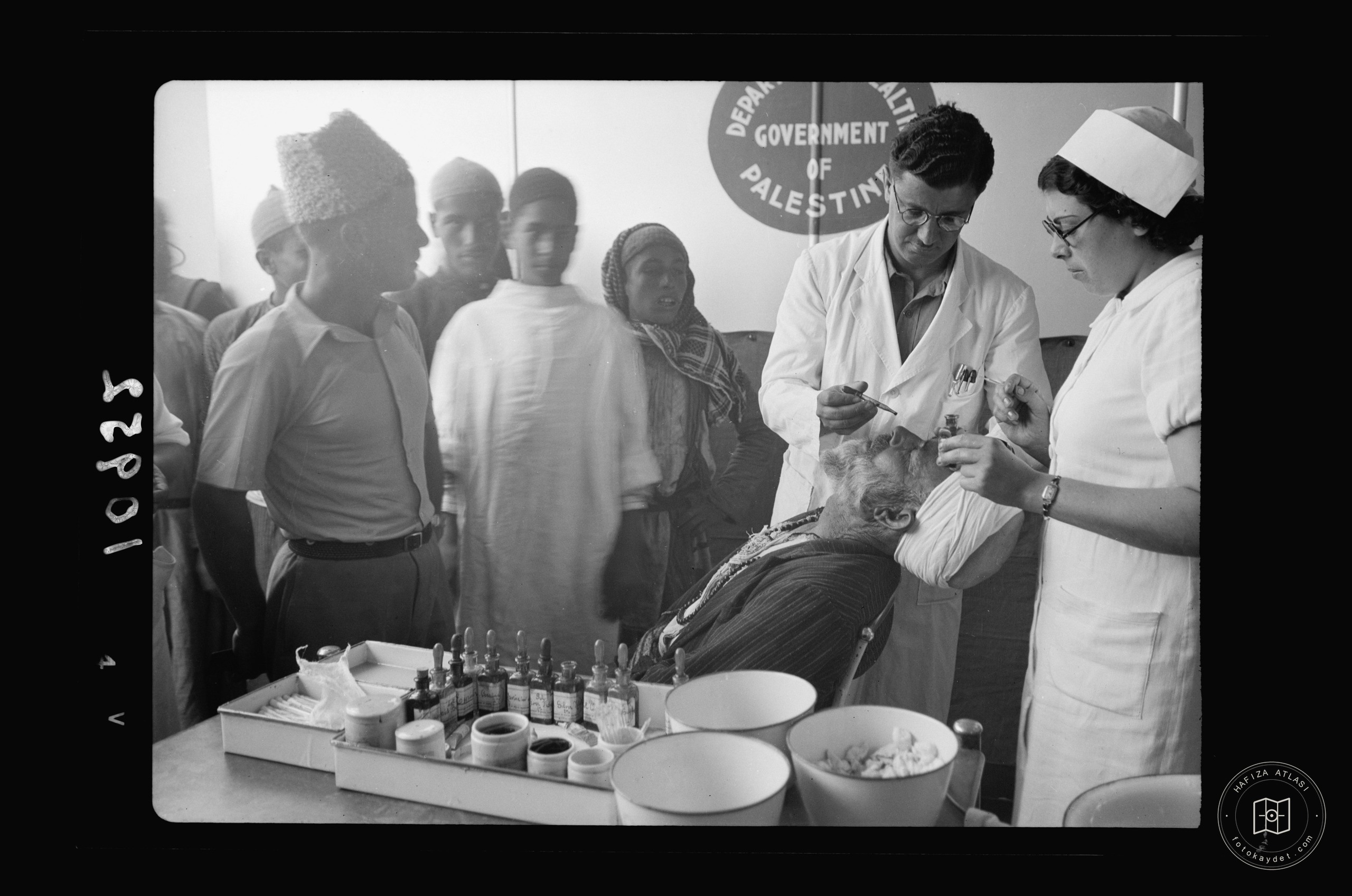 Doctor & nurse attending an older member of the village — mobile eye clinic near Gaza