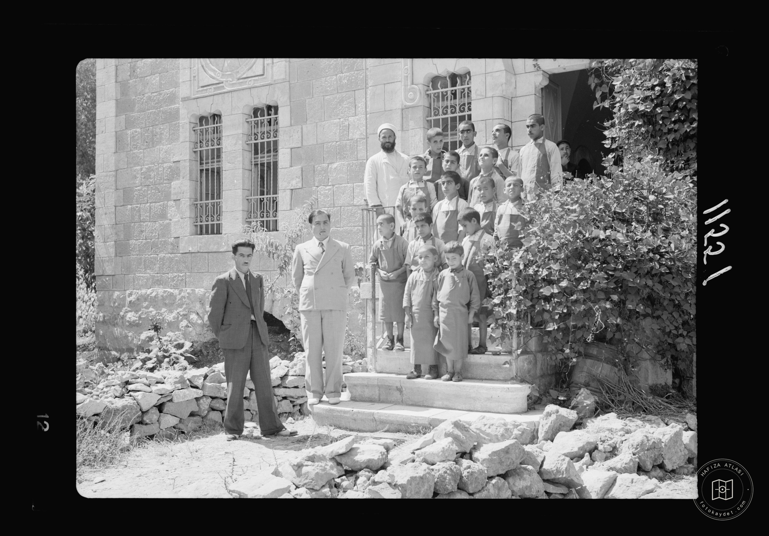 Blind school in Hebron. Group of the boys on steps of school bldg. building, Mr. Dajani, the principal