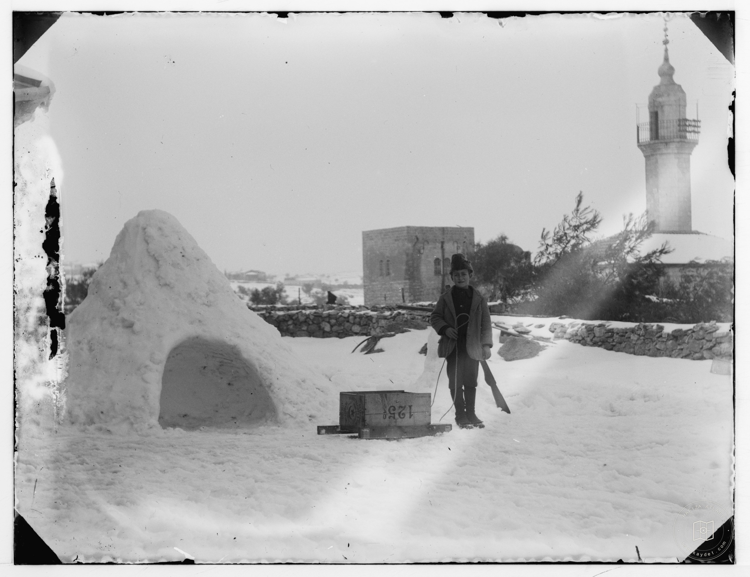 Snow in Jerusalem, 1921. Man with box on sled
