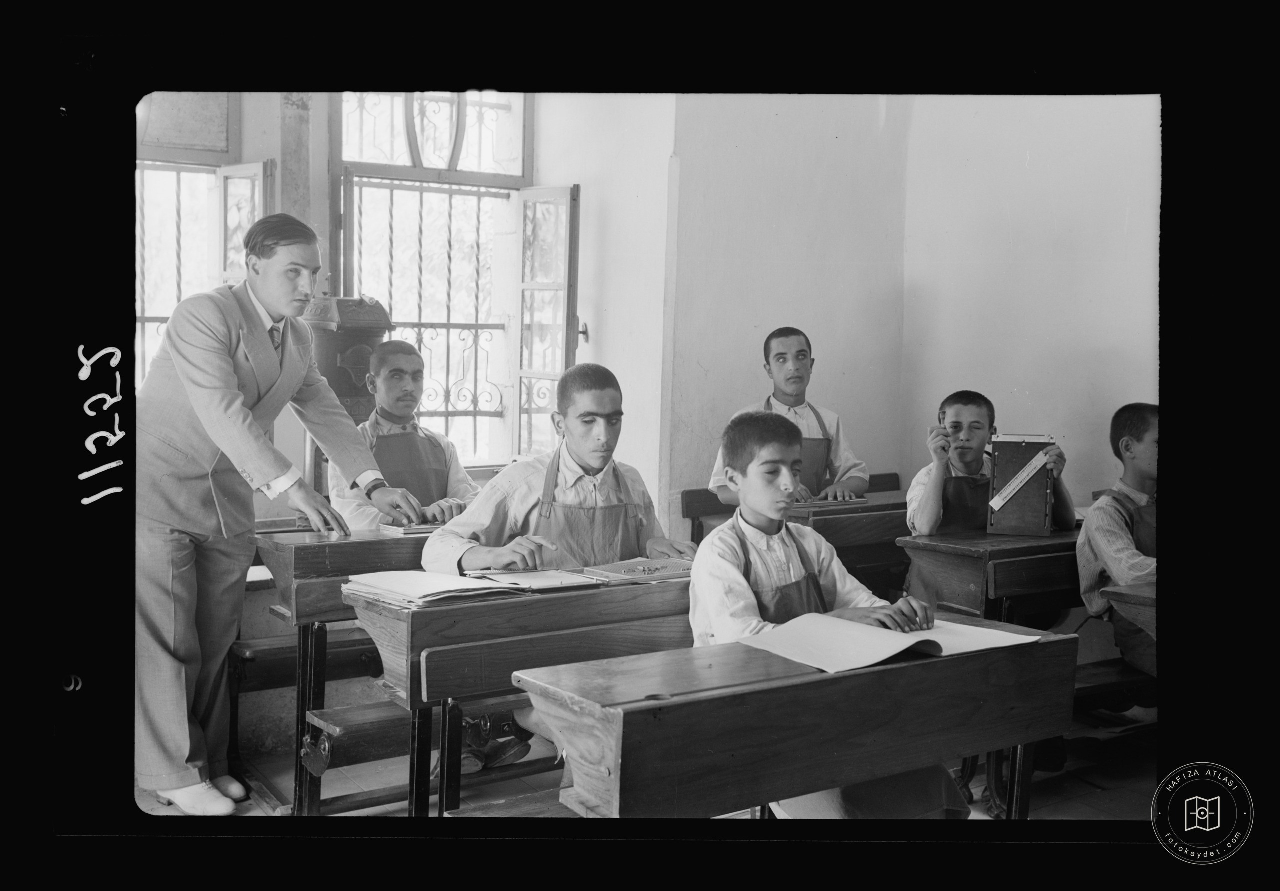 Blind school in Hebron. Class of older boys reading braille
