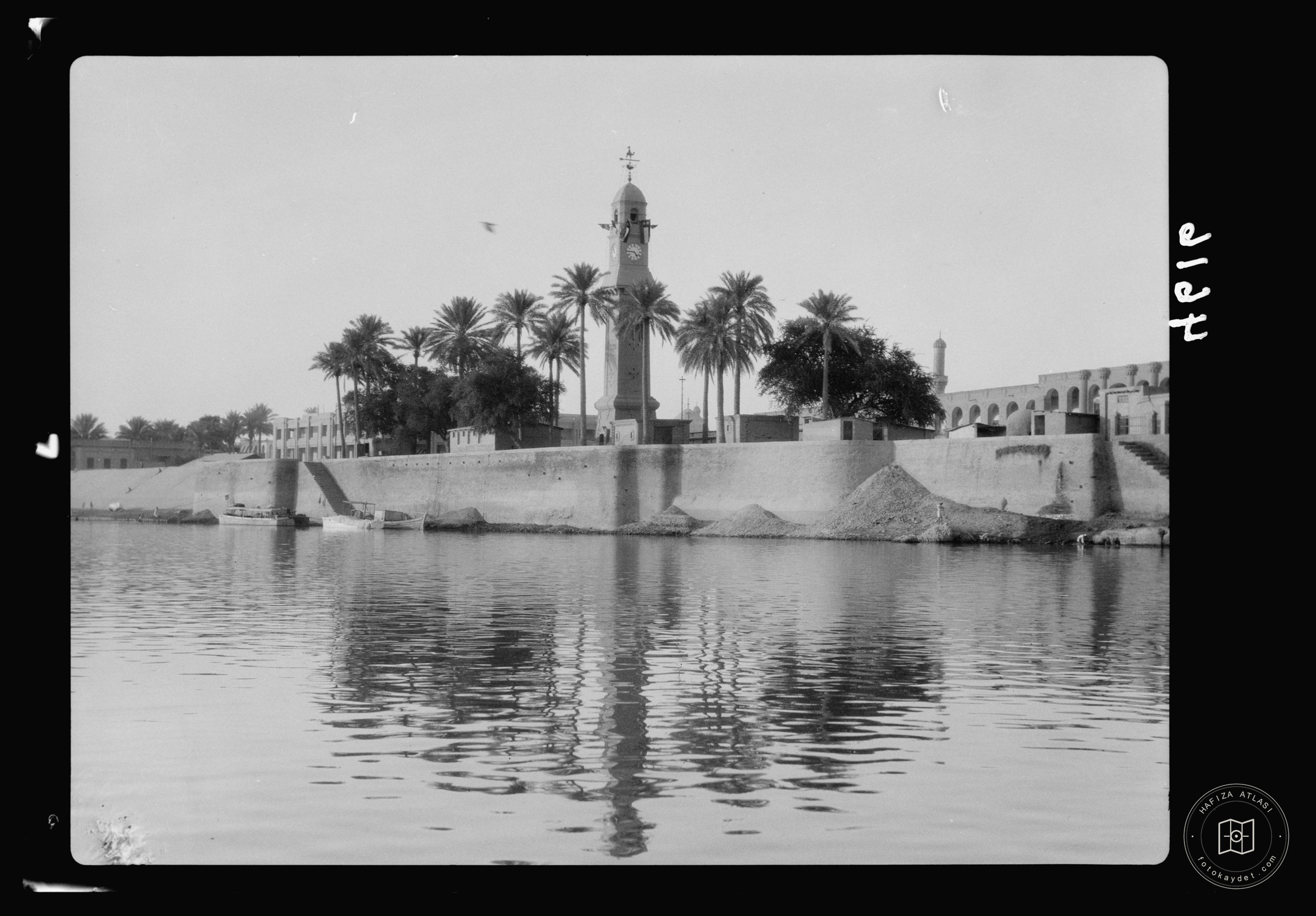 Baghdad. The Tigris. The clock tower on the river's banks. The citadel is seen in the distance