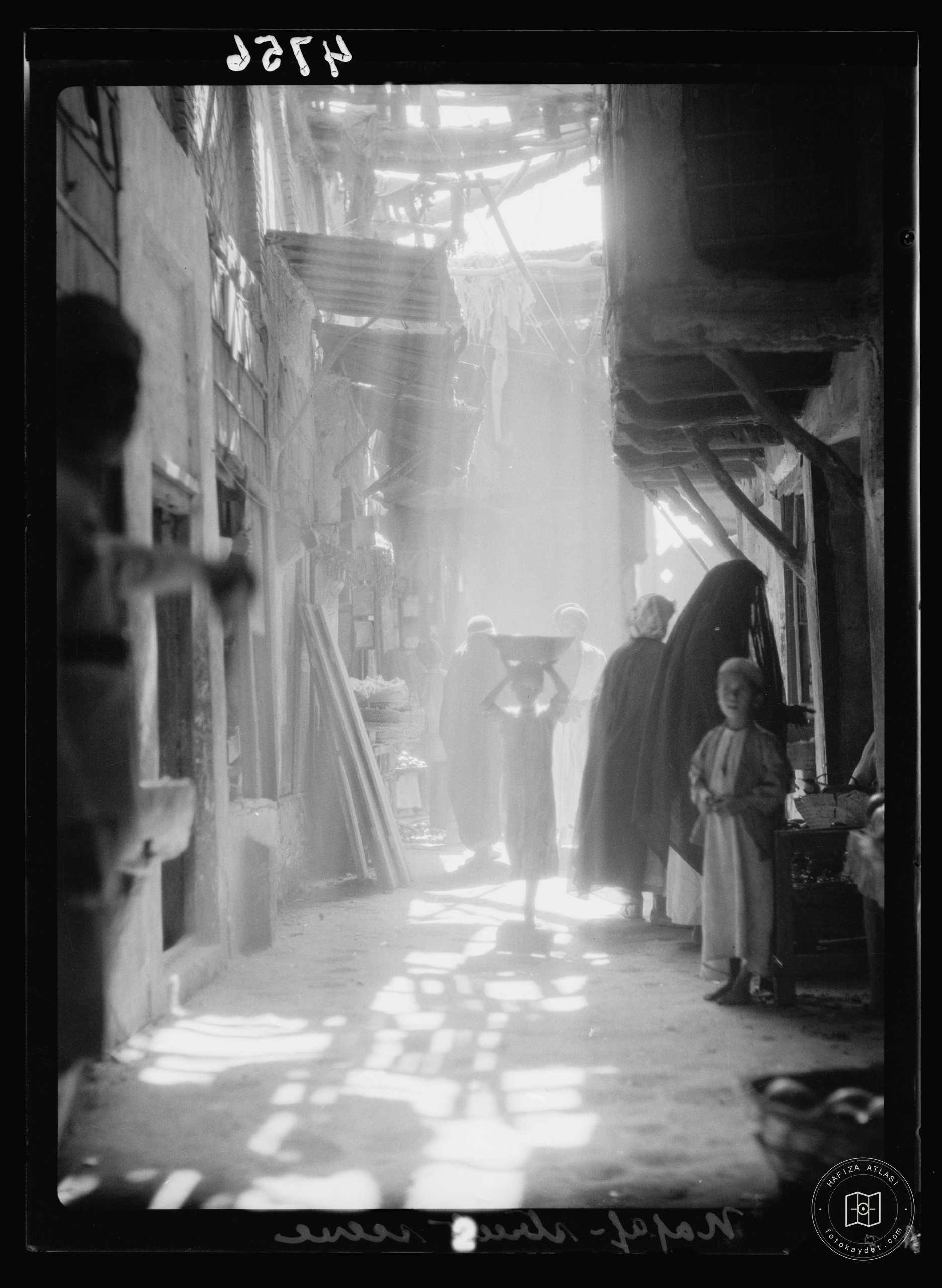 Nejaf. First sacred city of the Shiite Muslims. A narrow street. The noonday sun filtering through awnings