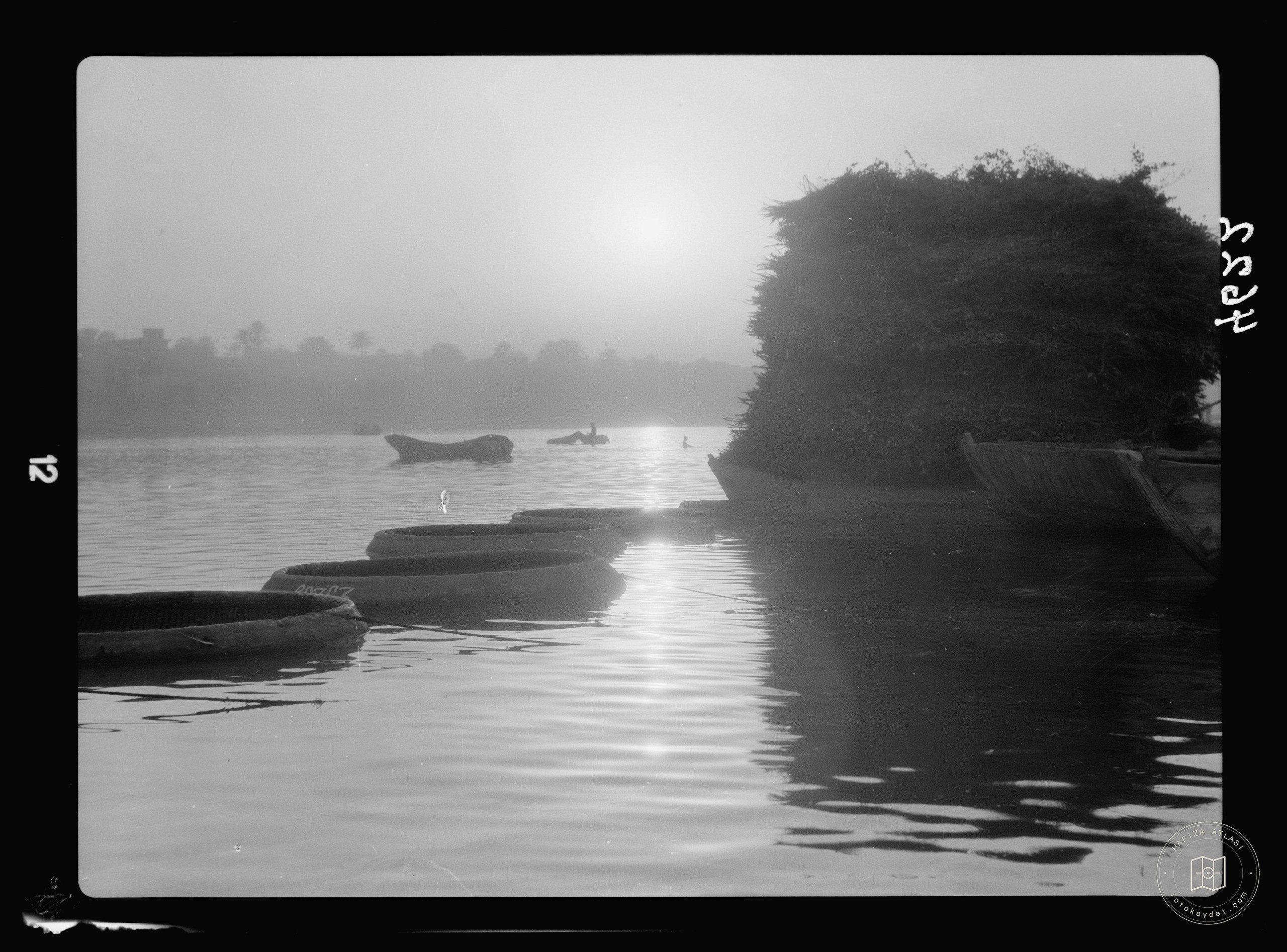 Baghdad. The Tigris. Sunset scene with ghuffas and fuel raft