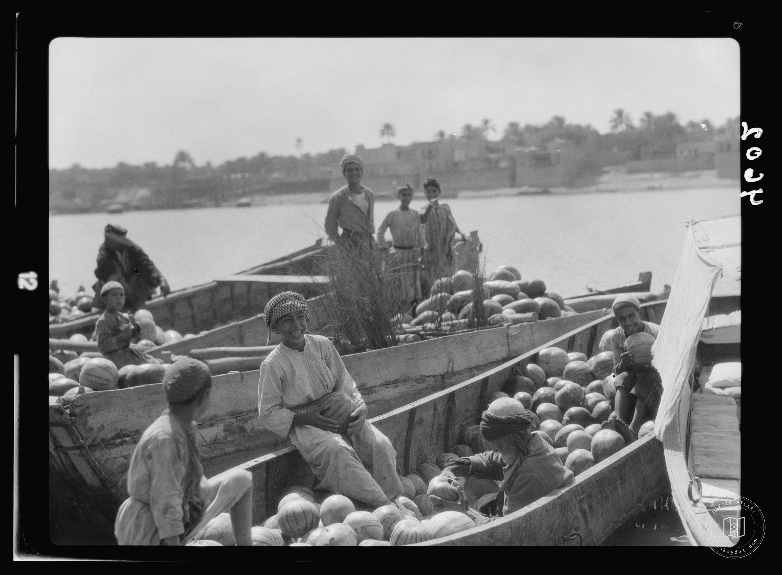 Baghdad. Barges of watermelons with typical Iraqi boys