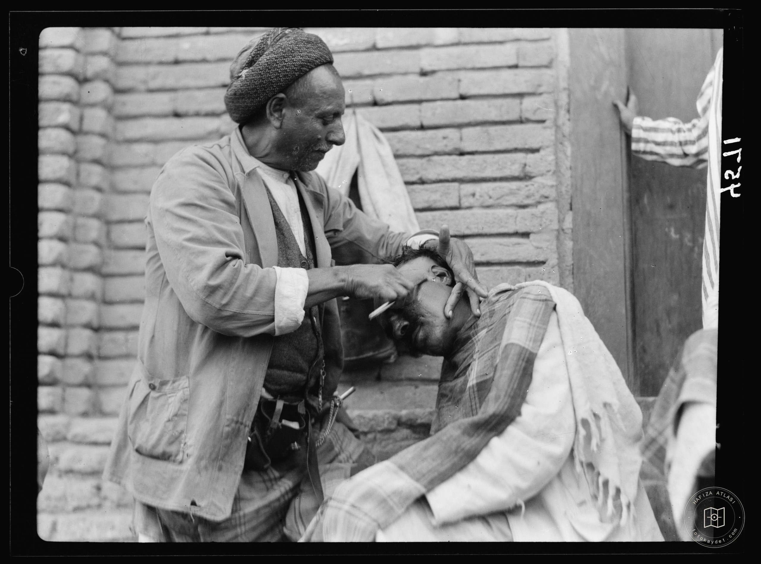 Baghdad. Street barber at work