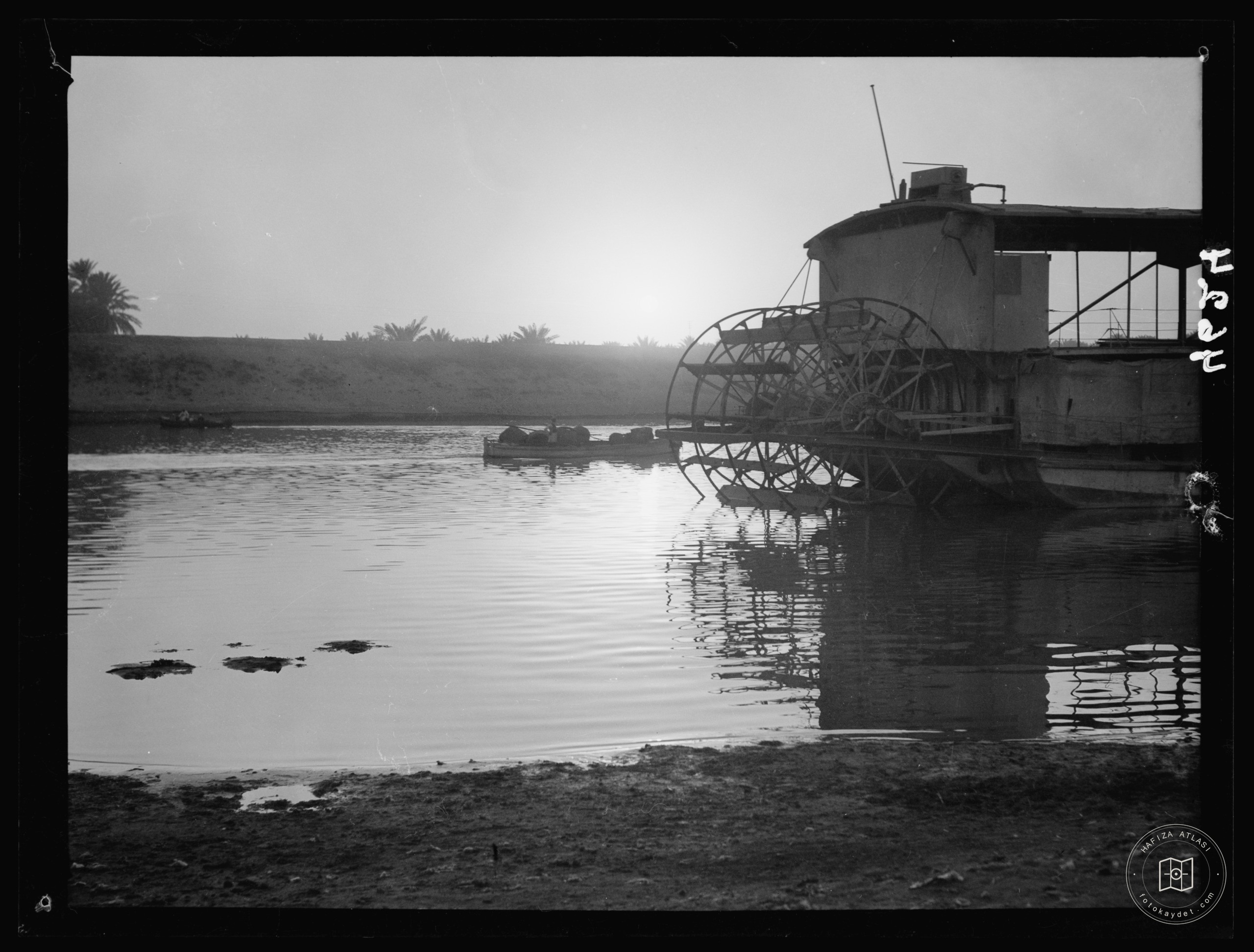 Baghdad. The Tigris. A sunset silhouette. A river boat with paddle wheel