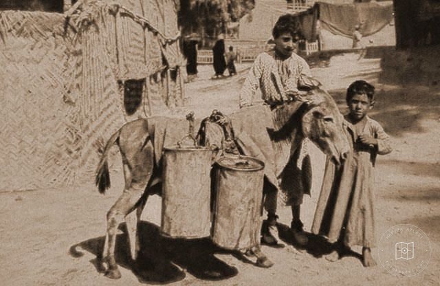 Iraq — Water carriers at an Assyrian refugee camp near Baghdad