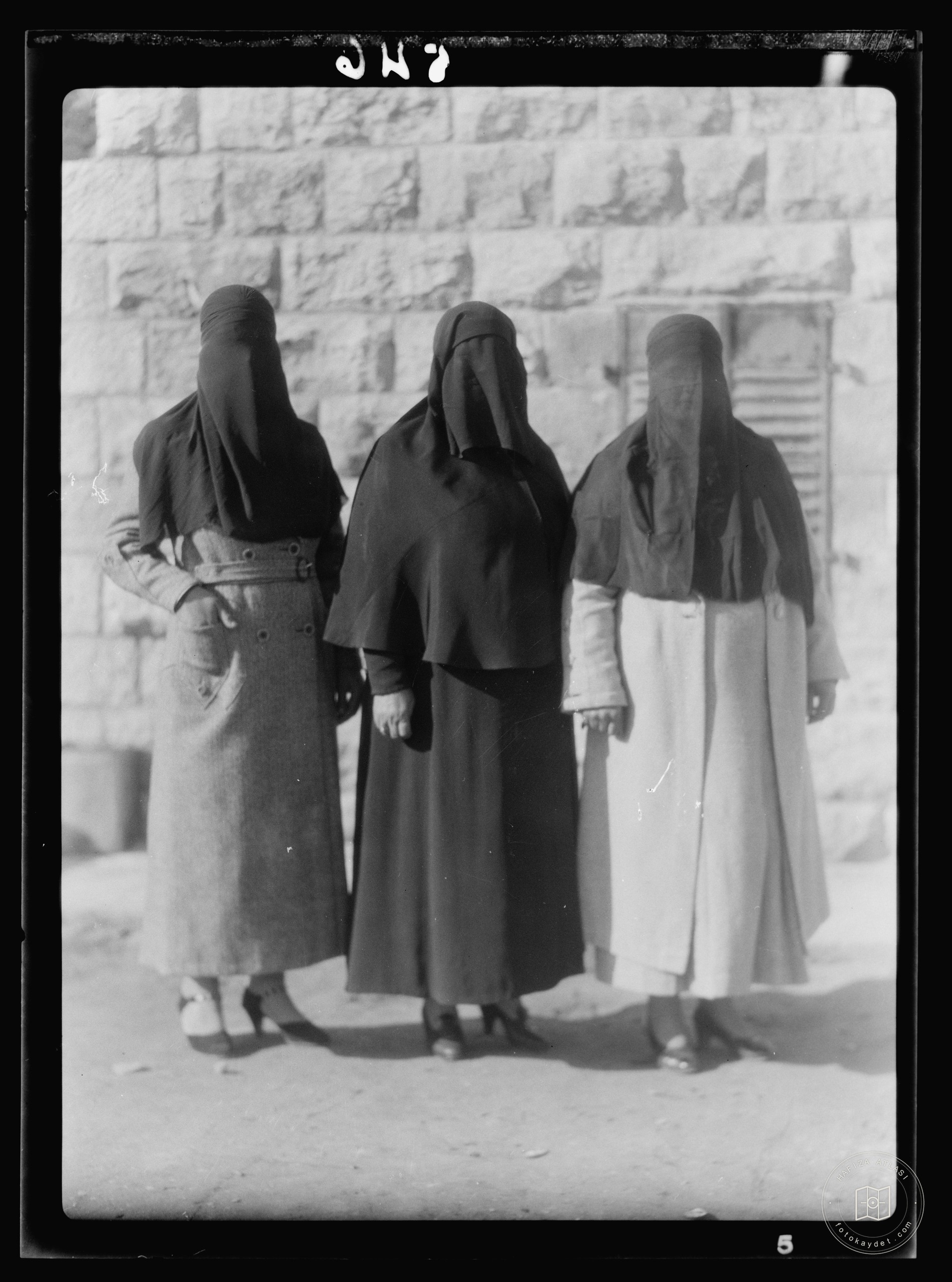 Women in traditional veiled dress