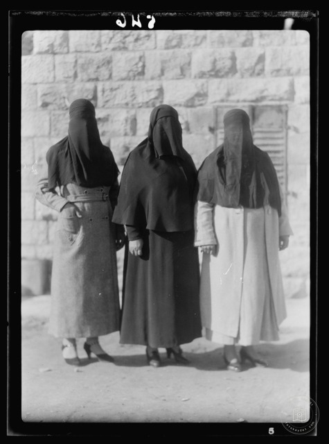 Women in traditional veiled dress