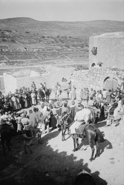Crowd Gathered On Village Hill (All Looking At Man On House. Turkish Flag)