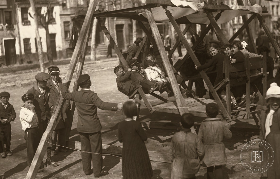 Children enjoying a traveling street swing in Istanbul