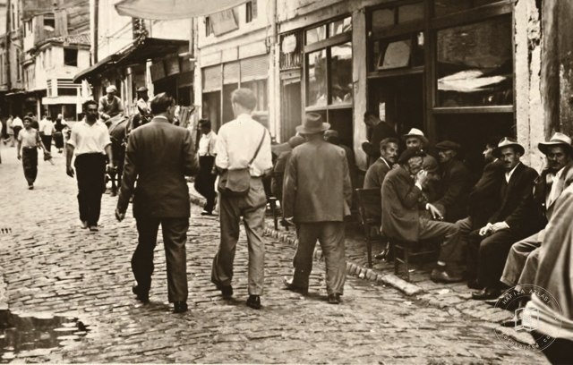 People passing time outside a coffeehouse on an Istanbul street