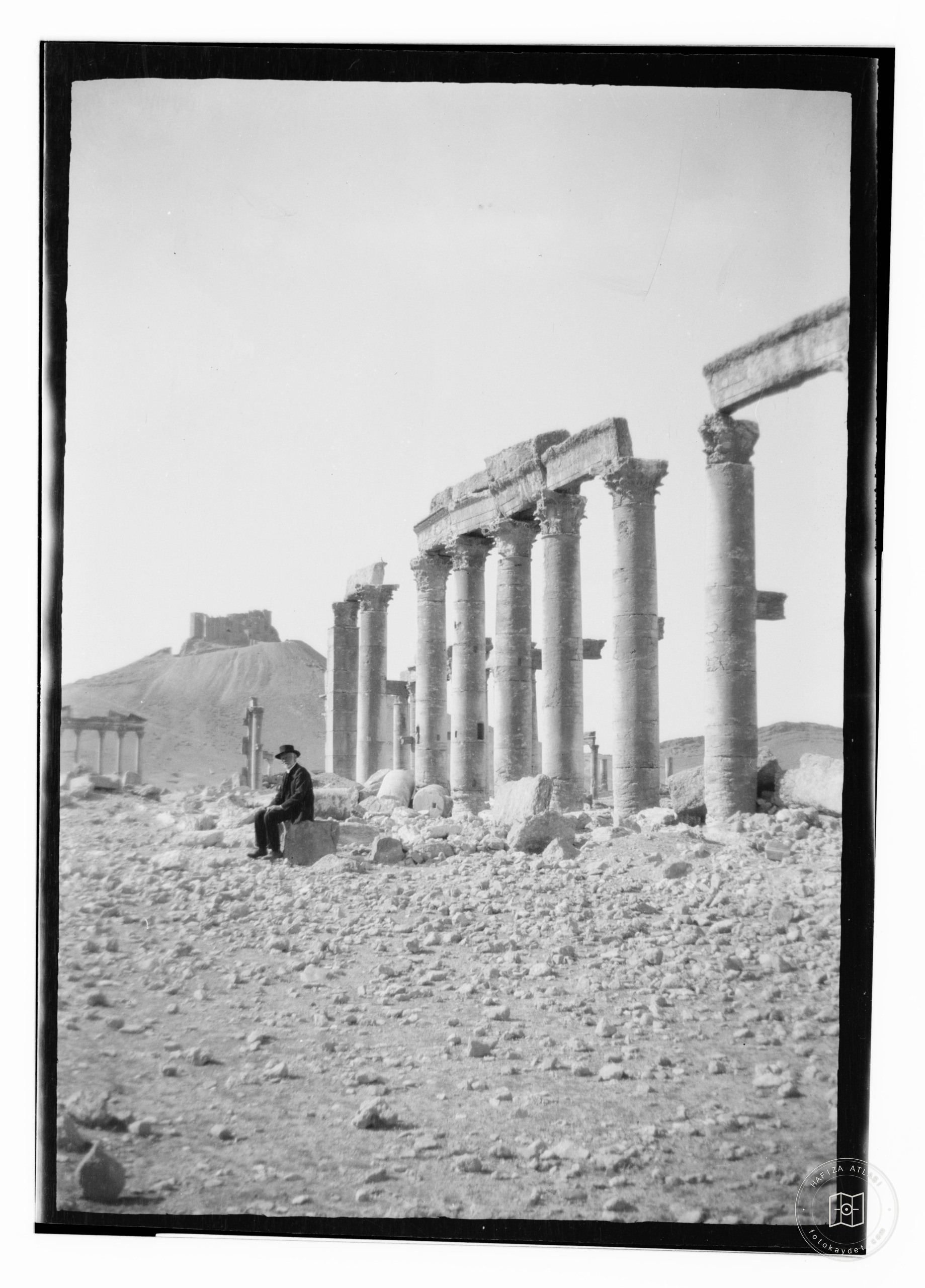 Man seated in ruins of Palmyra