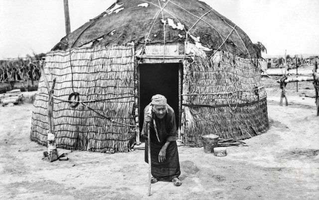 Turkmenistan — Elderly Woman with a Walking Stick beside a Yurt