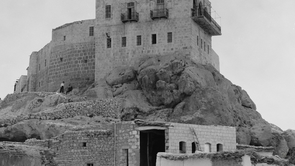 Deir Seidnaya showing the convent picturesquely perched on a cliff