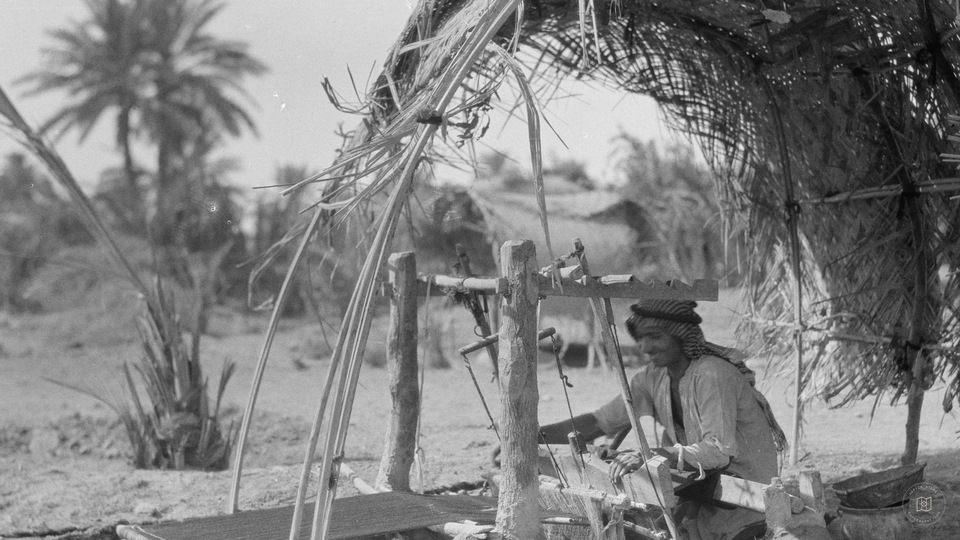 Kifl. Local Muslim village with a Jewish shrine to the prophet Ezekiel. Local weaver. At work on his loom