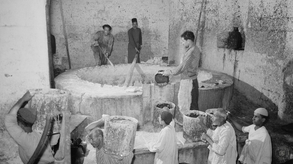 The Soap Factory. The boiling pot liquid soap being carried to stock room, Nablus